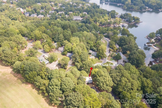 drone / aerial view featuring a water view and a forest view