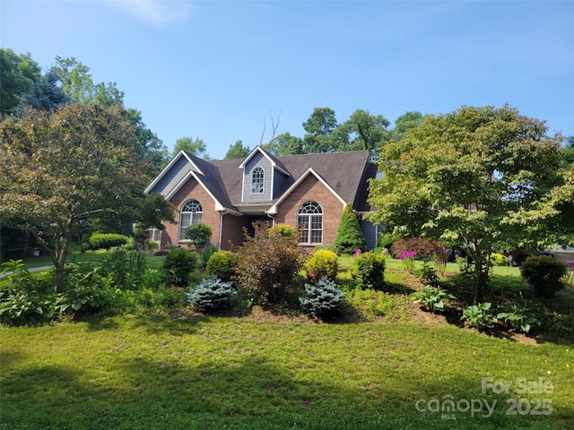 view of front of property with brick siding and a front yard