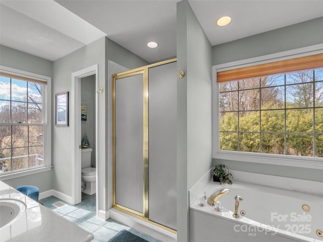 bathroom featuring baseboards, toilet, a garden tub, a shower stall, and a sink