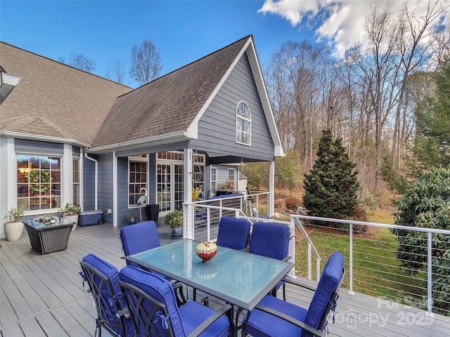 wooden terrace with outdoor dining area