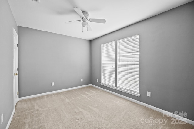 empty room with a ceiling fan, baseboards, and carpet flooring