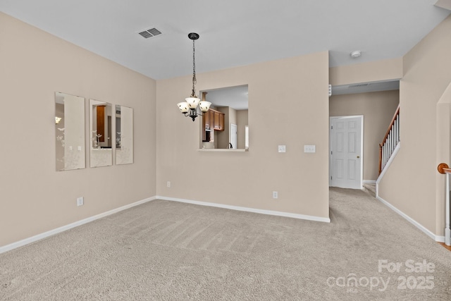 carpeted spare room with baseboards, stairs, visible vents, and a chandelier