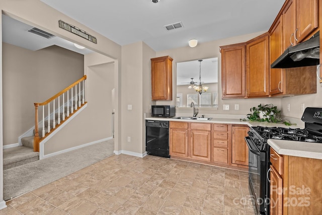 kitchen with under cabinet range hood, a sink, visible vents, light countertops, and black appliances