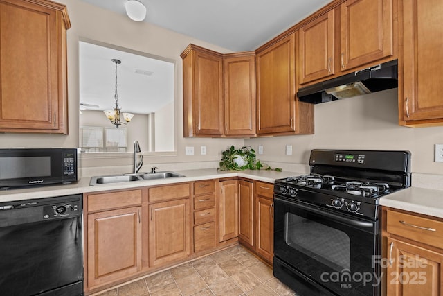 kitchen featuring visible vents, light countertops, a sink, under cabinet range hood, and black appliances