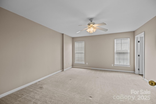 unfurnished room featuring carpet floors, ceiling fan, and baseboards