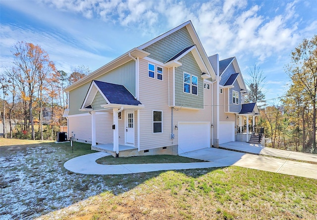 view of front of home featuring crawl space, a garage, cooling unit, and concrete driveway