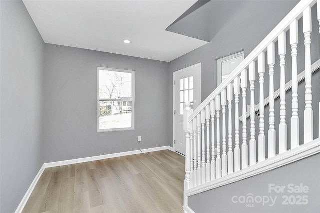 entryway featuring recessed lighting, stairway, baseboards, and wood finished floors