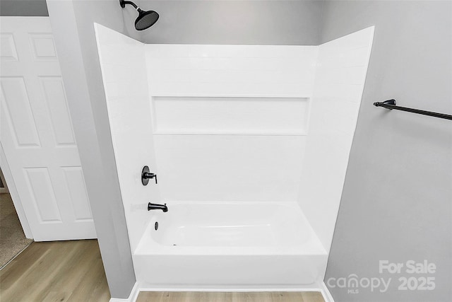 full bath featuring shower / tub combination and wood finished floors