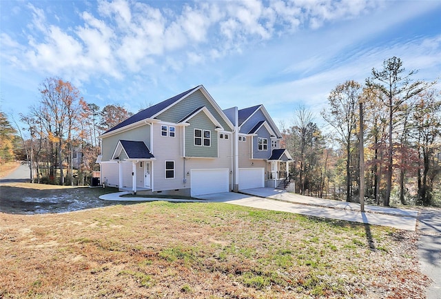 view of front of property featuring a garage, crawl space, driveway, and a front lawn