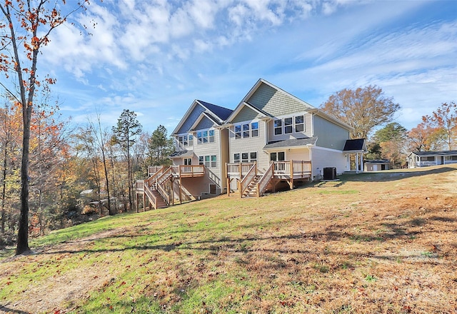 back of house with cooling unit, stairway, a deck, and a lawn