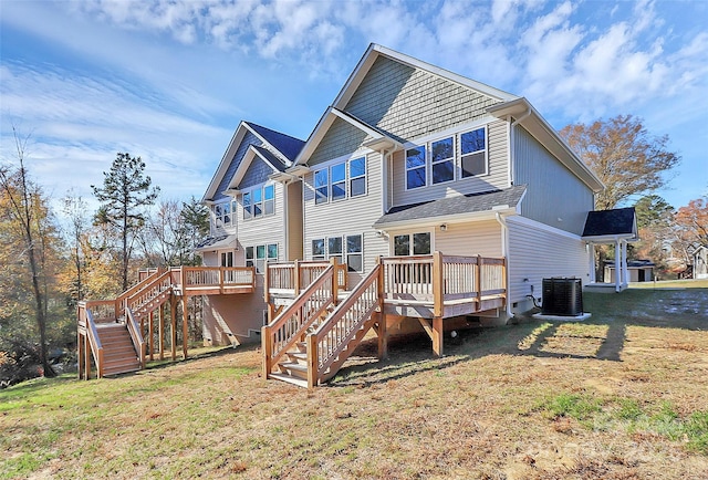 back of house with a deck, a yard, stairway, and central air condition unit