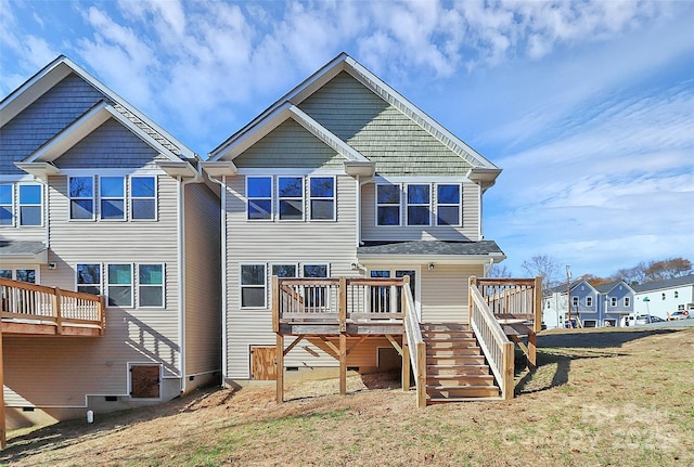 rear view of house featuring a deck, stairway, and crawl space