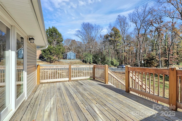 deck featuring an outdoor structure and a shed