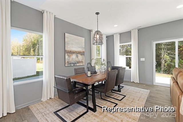 dining room with plenty of natural light, light wood-type flooring, and recessed lighting