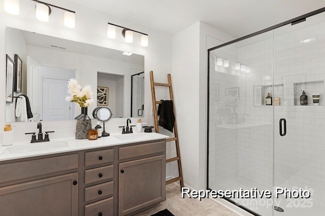 bathroom with double vanity, a sink, and a shower stall