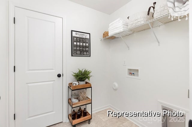 clothes washing area featuring laundry area, hookup for a washing machine, and baseboards