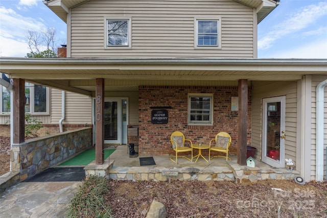 back of property featuring a patio area and brick siding