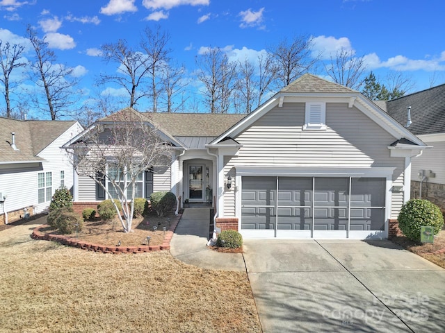 view of front facade featuring brick siding, a shingled roof, concrete driveway, an attached garage, and a front lawn