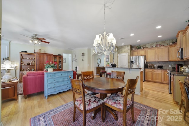 dining space with recessed lighting, visible vents, ornamental molding, light wood-type flooring, and ceiling fan with notable chandelier