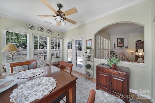 dining area with ornamental molding, a wealth of natural light, and visible vents