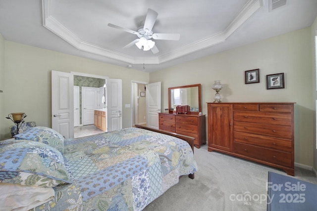 bedroom featuring light colored carpet, a tray ceiling, visible vents, and crown molding