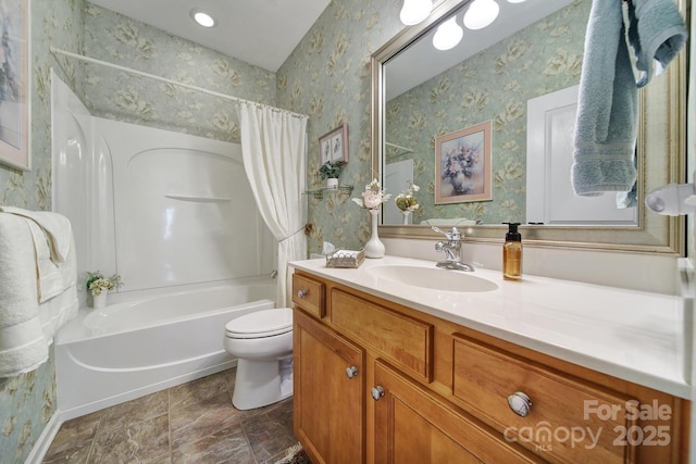 bathroom featuring shower / bath combo, vanity, toilet, and wallpapered walls