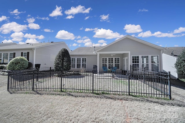 rear view of house with ceiling fan, a patio area, and fence