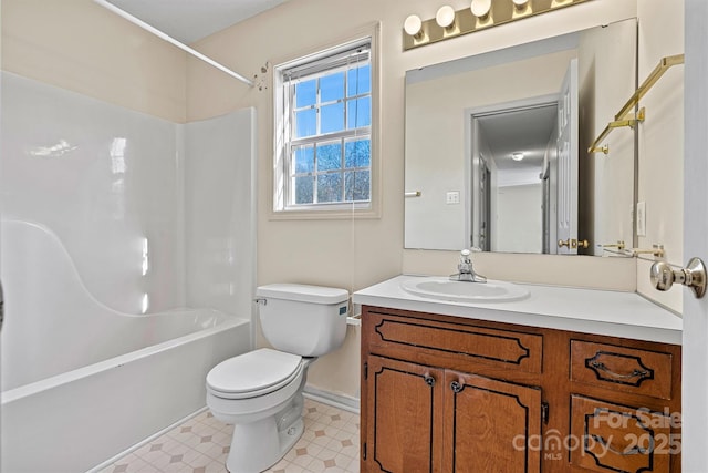 full bath featuring shower / tub combination, toilet, vanity, baseboards, and tile patterned floors