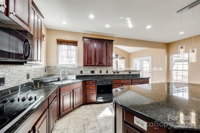 kitchen with light tile patterned floors, hanging light fixtures, backsplash, a sink, and black appliances