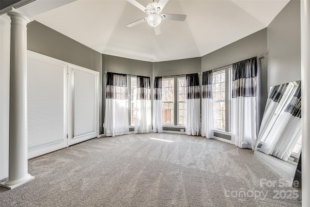 interior space with ornate columns, ceiling fan, and vaulted ceiling