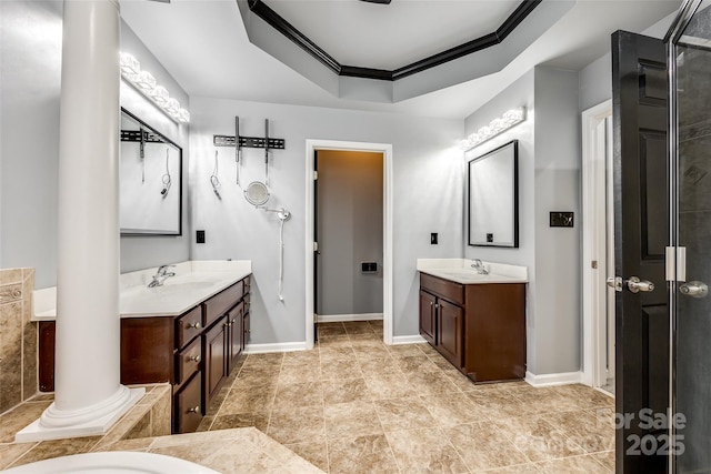 full bathroom featuring ornate columns, a tray ceiling, a sink, and ornamental molding