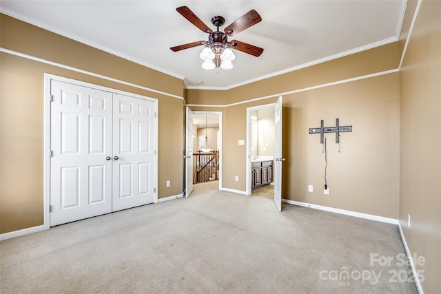 unfurnished bedroom with light carpet, crown molding, and baseboards