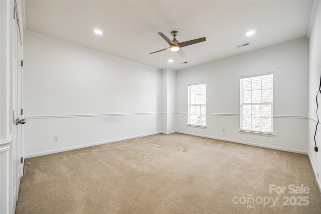 unfurnished room with light carpet, crown molding, and baseboards