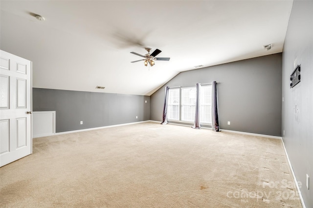 bonus room with baseboards, visible vents, a ceiling fan, vaulted ceiling, and carpet flooring