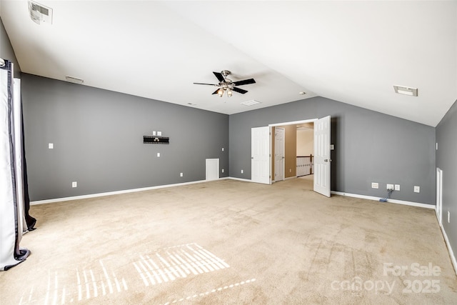 interior space with lofted ceiling, light carpet, visible vents, and baseboards