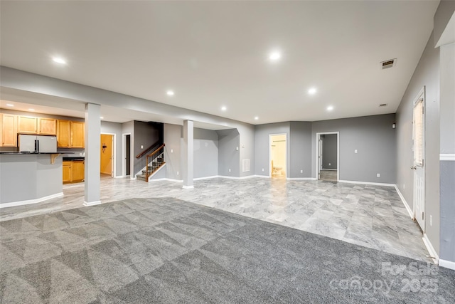 unfurnished living room featuring recessed lighting, visible vents, baseboards, and stairs