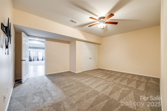 unfurnished bedroom featuring visible vents, baseboards, a ceiling fan, carpet, and a closet