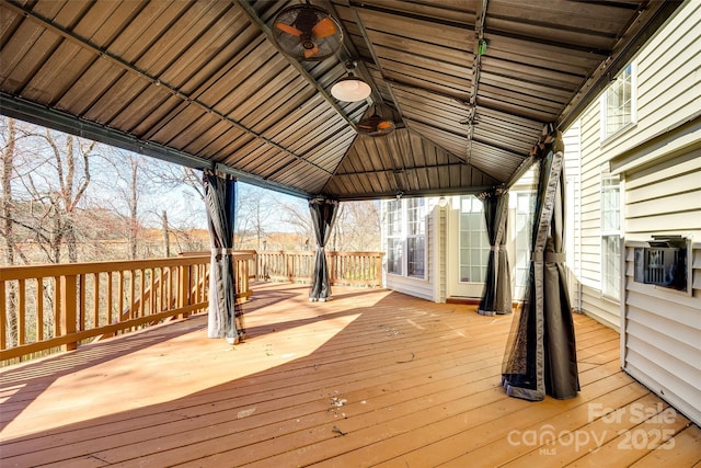 wooden terrace with cooling unit and a gazebo