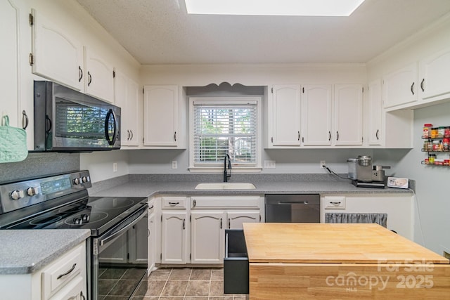 kitchen featuring black electric range, a sink, white cabinets, and dishwasher