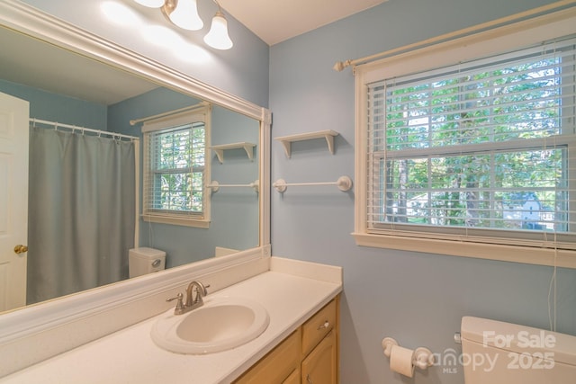 bathroom featuring toilet and vanity