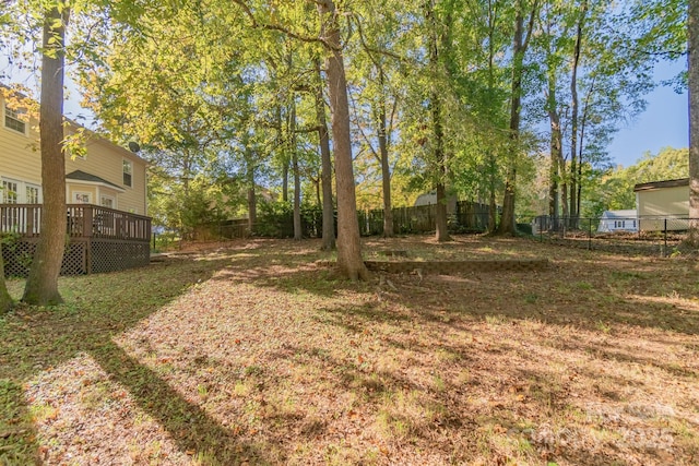 view of yard with a fenced backyard and a wooden deck