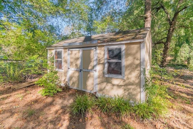 view of shed with fence