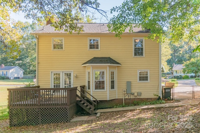 back of house featuring a gate, fence, and a deck