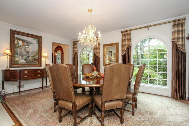 dining area featuring a healthy amount of sunlight, a chandelier, and crown molding