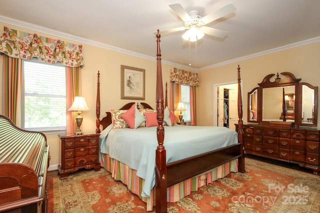 bedroom featuring a walk in closet, crown molding, wood finished floors, and a closet