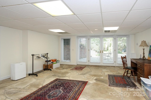 home office with visible vents, a paneled ceiling, and baseboards