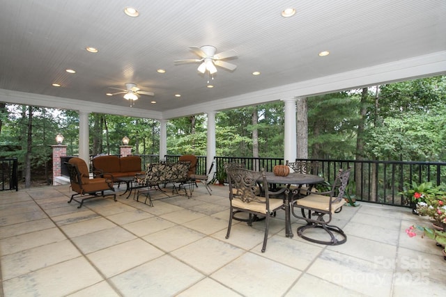 view of patio with outdoor dining area, an outdoor hangout area, and a ceiling fan