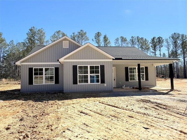 view of front of property with a shingled roof and board and batten siding