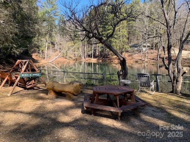 view of yard with a water view and fence