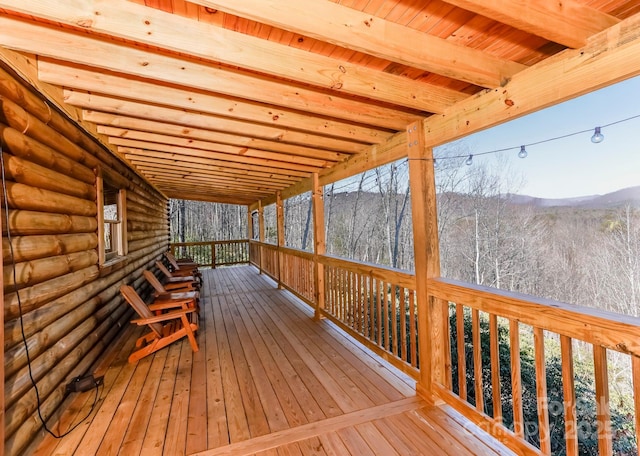 wooden terrace with a wooded view